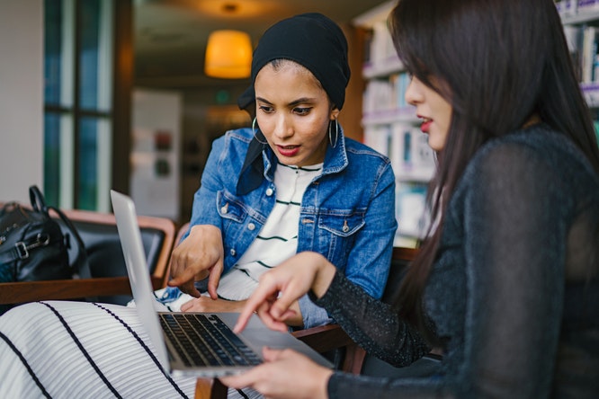 Two ladies looking at laptop screen