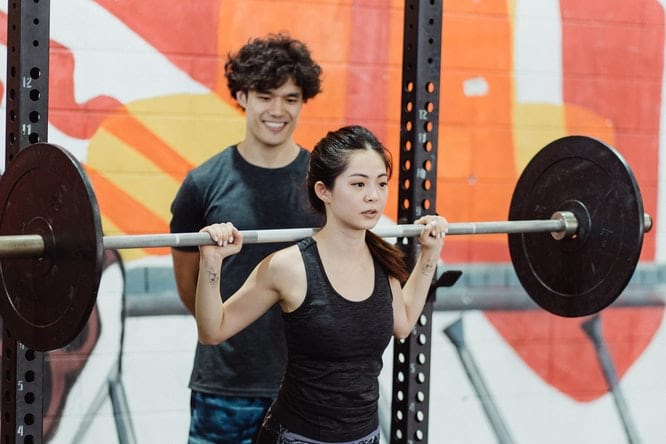 Individuals lifting weights