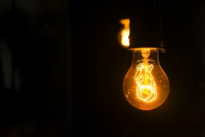light bulb lit in a dark room