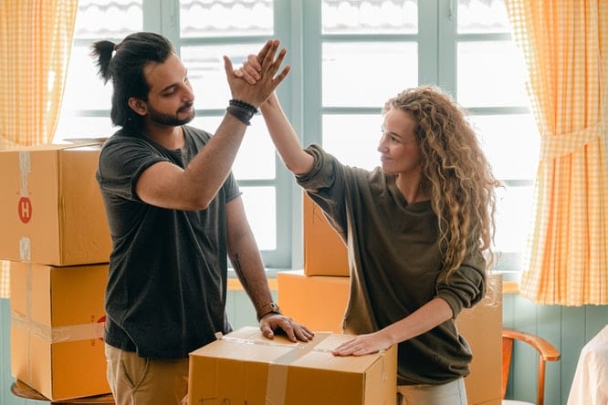 Couple unpacking boxes in new home