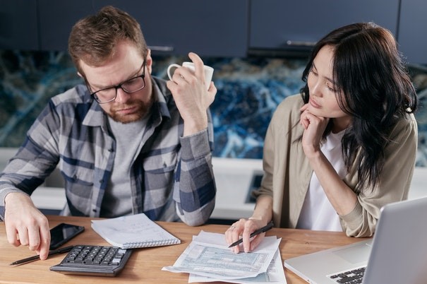 man and woman working on taxes