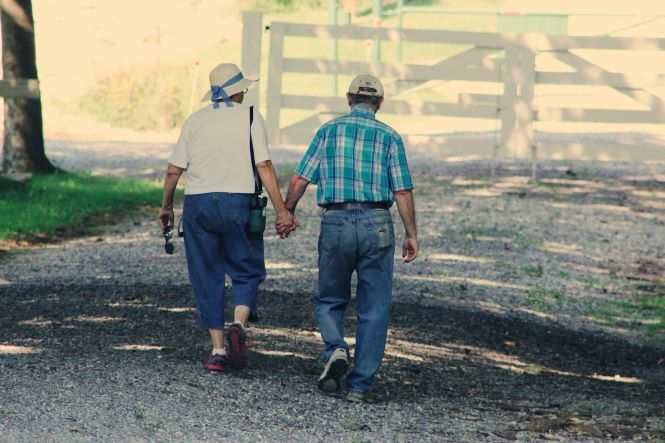 old couple walking down road