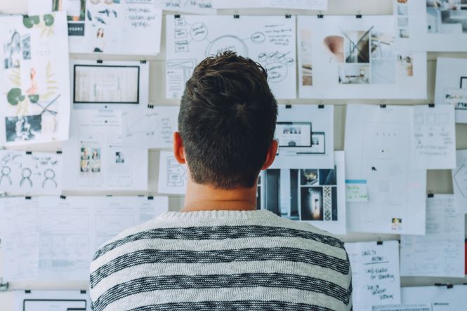 man looking at vision board