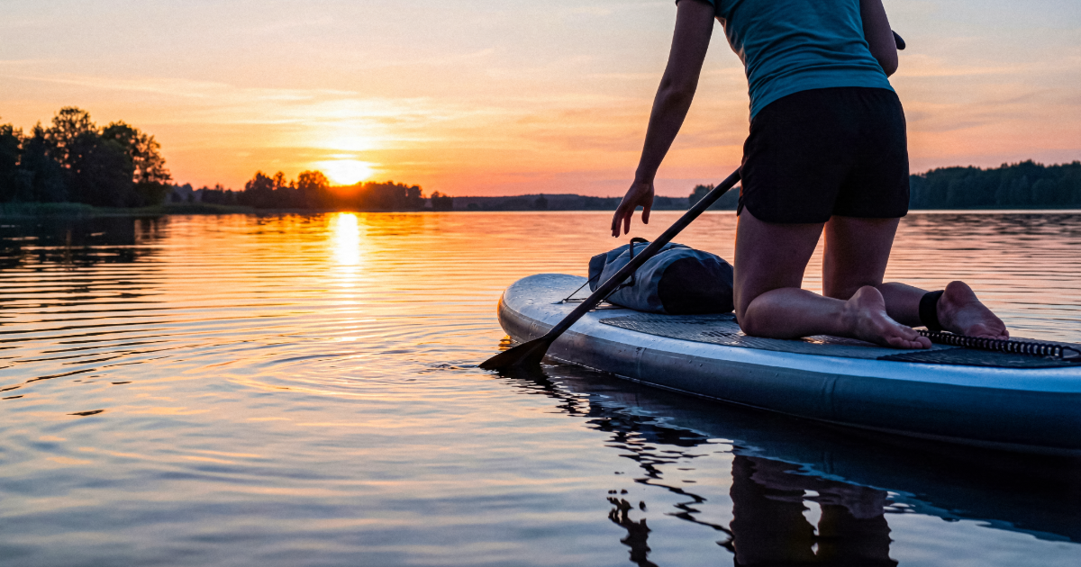 Person paddle boarding on lake