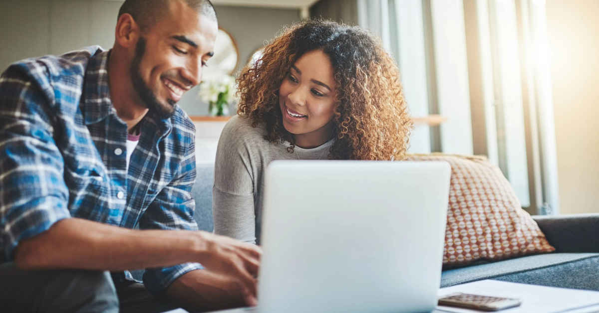 Couple consolidating debt on laptop