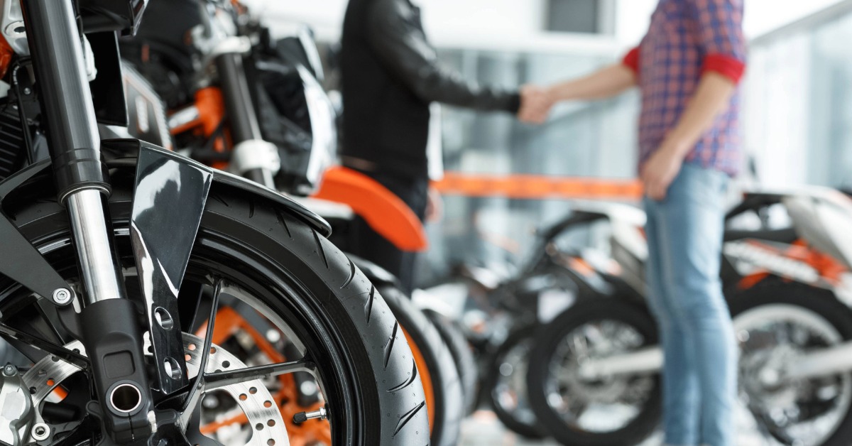 Customer with motorcycle loan at dealership.