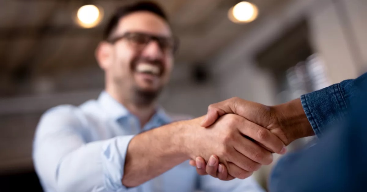 smiling man shaking hand