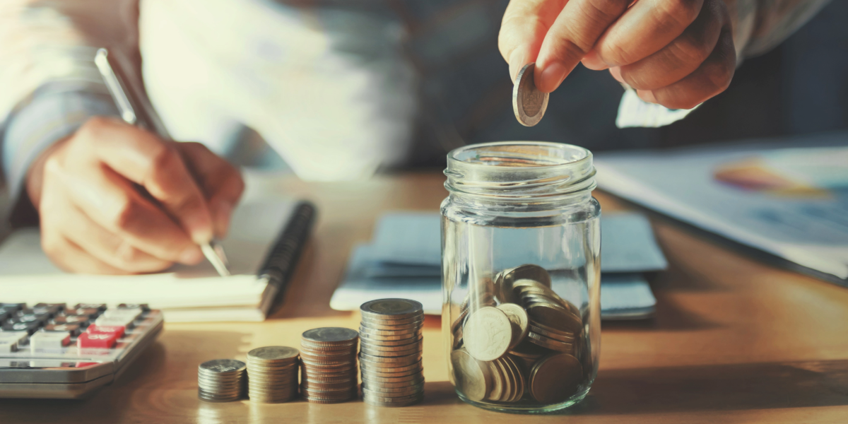 Person counting coins from a jar