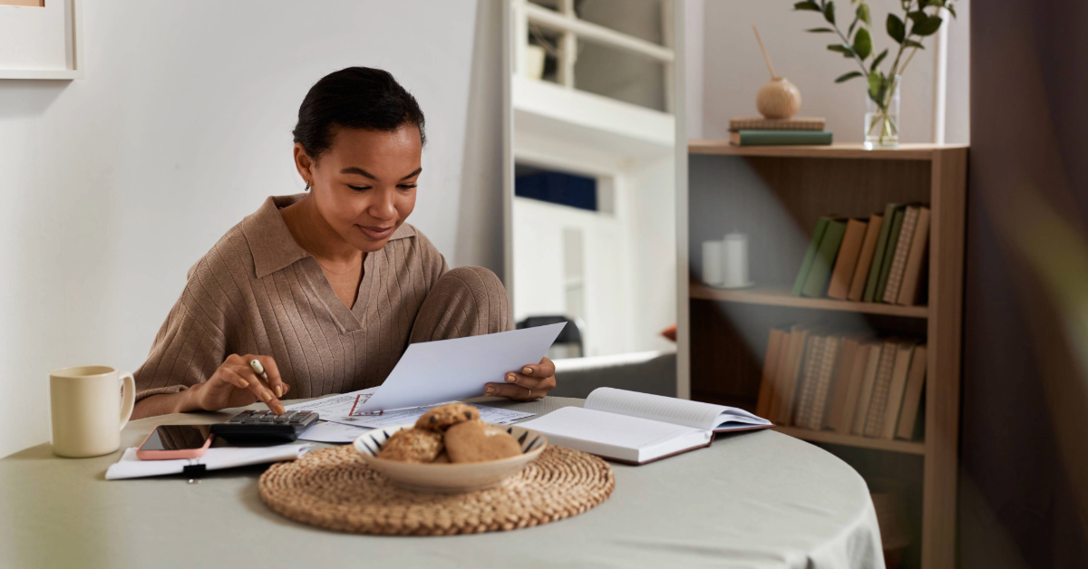 Woman doing her taxes with a guide from MIT FCU.